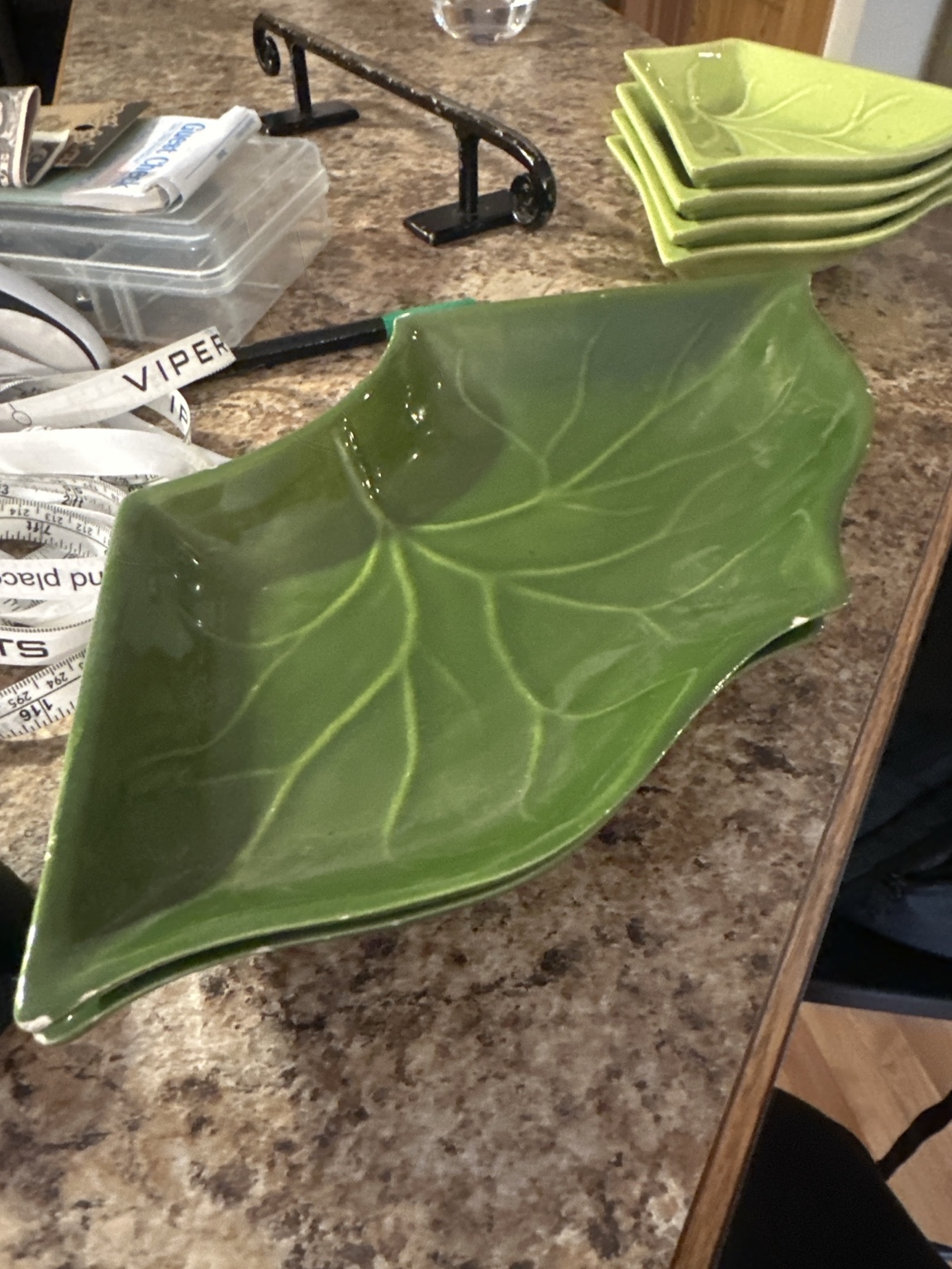 An olive green leaf-shaped serving dish